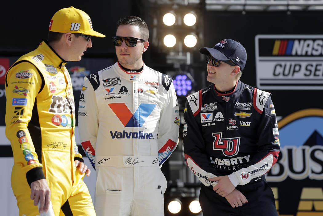 Kyle Busch, left, Alex Bowman, center, and William Byron talk during introductions before the N ...