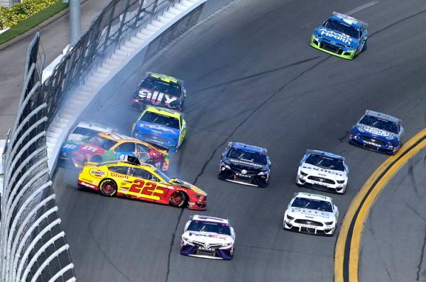 Joey Logano (22), Kyle Busch (18) and Brad Keselowski (2) collide in Turn 4 during the NASCAR D ...