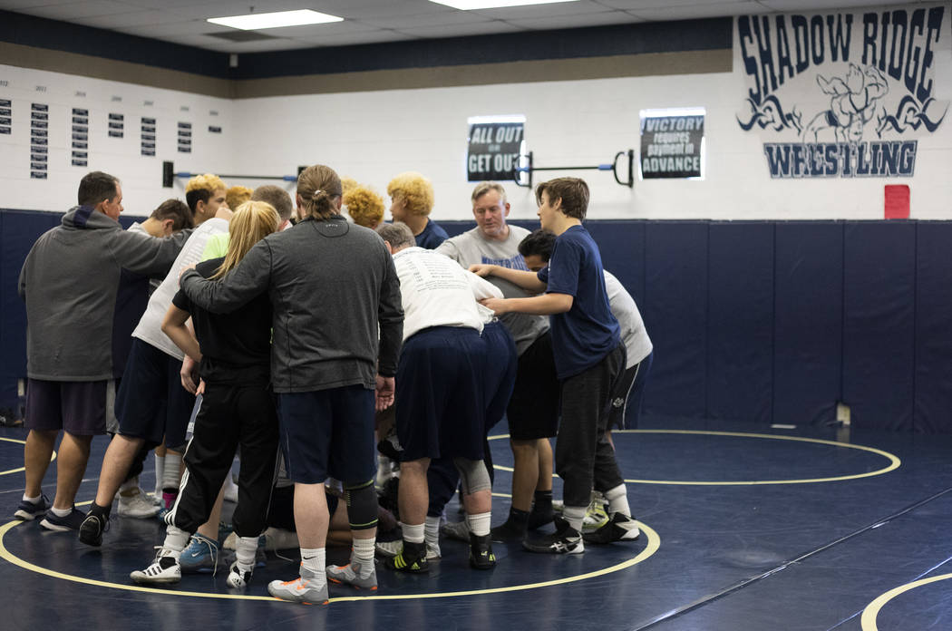 The Shadow Ridge High School wrestling team does a final chant after practice at Shadow Ridge H ...