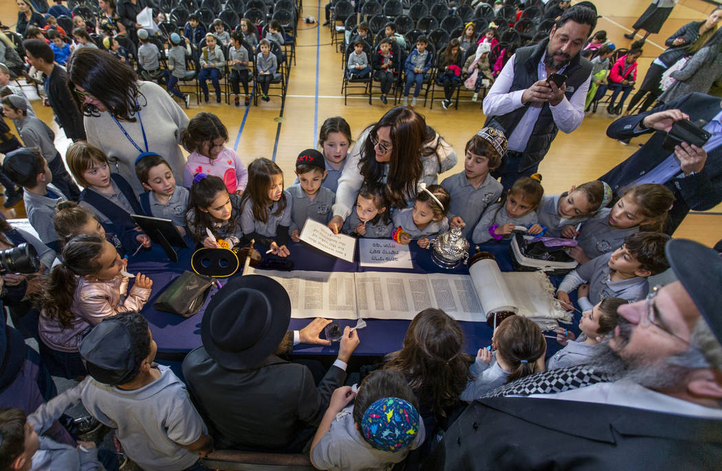 Rabbi Dovid Bressman, bottom left, as Sofer readies to inscribe the new Torah surrounded by fir ...
