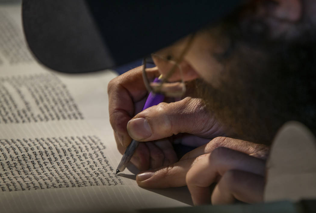 Rabbi Dovid Bressman as Sofer inscribe s the last few words on the new Torah during a ceremony ...