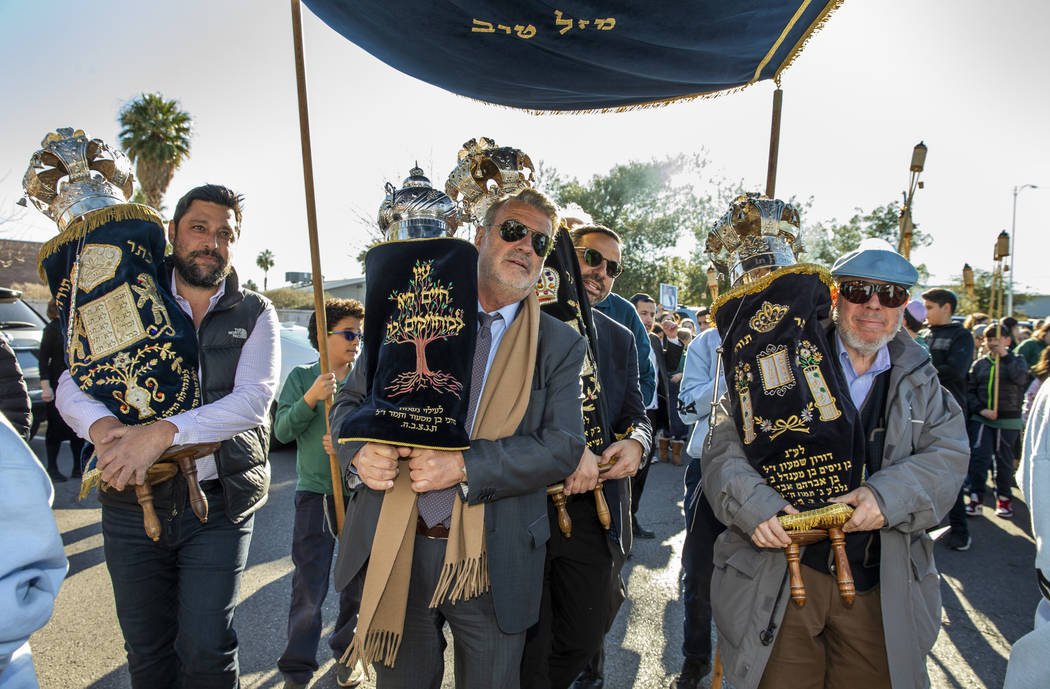 Chabad of Southern Nevada members join their new Torah with the three existing ones into to the ...