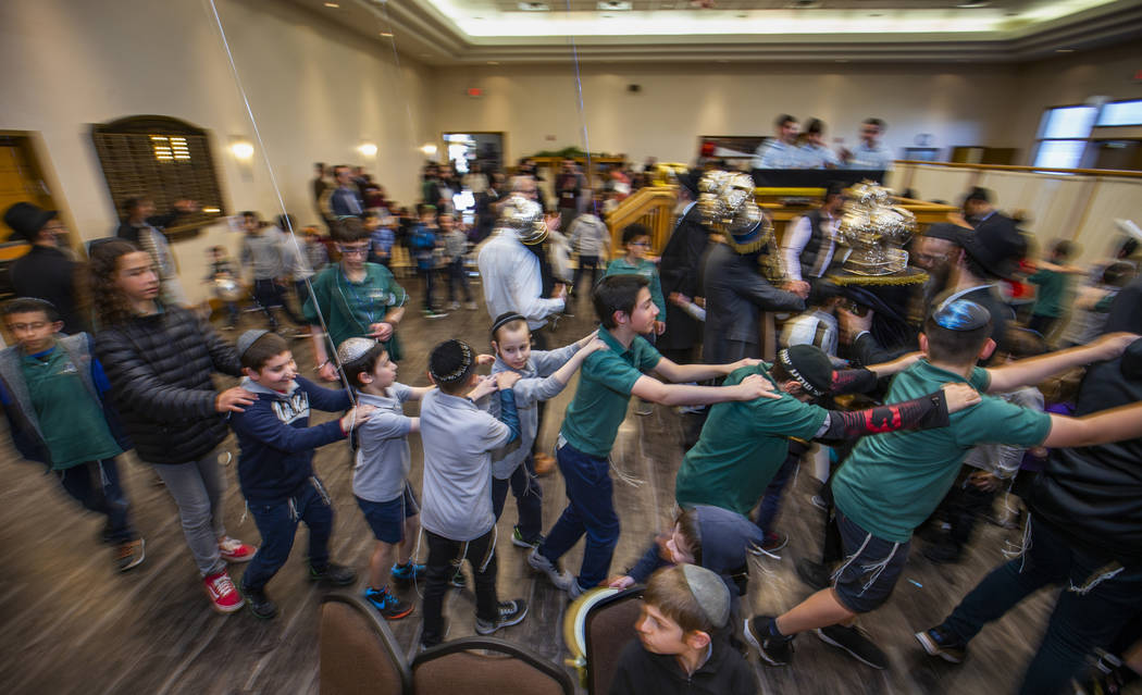 Chabad of Southern Nevada members dance with their new Torah and the three existing ones about ...