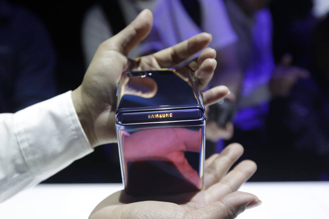 A Samsung worker gives a demonstration of the Galaxy Z Flip Phone at the Unpacked 2020 event in ...