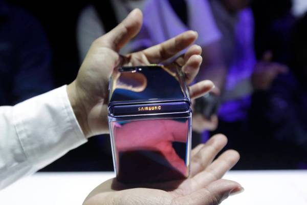 A Samsung worker gives a demonstration of the Galaxy Z Flip Phone at the Unpacked 2020 event in ...