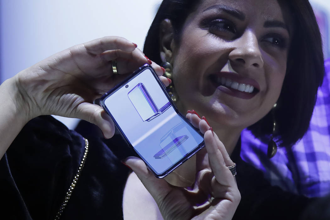 A woman holds a Samsung Galaxy Z Flip Phone displayed at the Unpacked 2020 event in San Francis ...