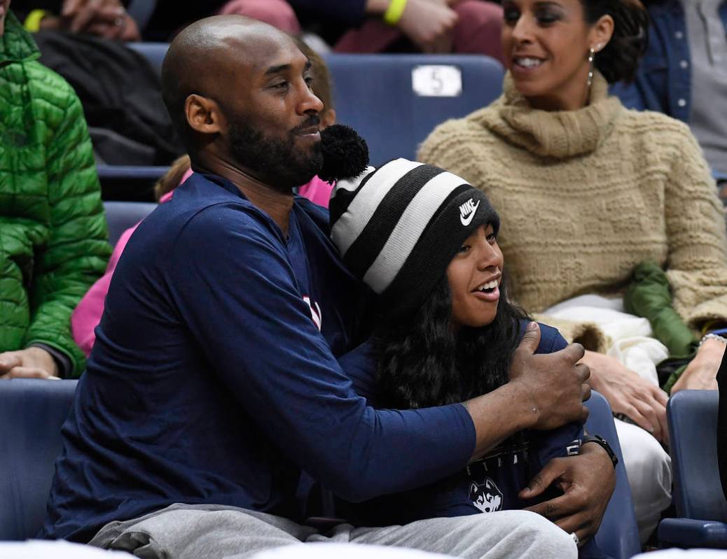 FILE - In this March 2, 2019, file photo Kobe Bryant and his daughter Gianna watch the first ha ...