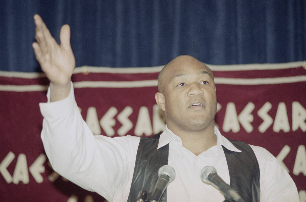 Former world heavyweight champion George Foreman gestures as he speaks at news conference in Lo ...