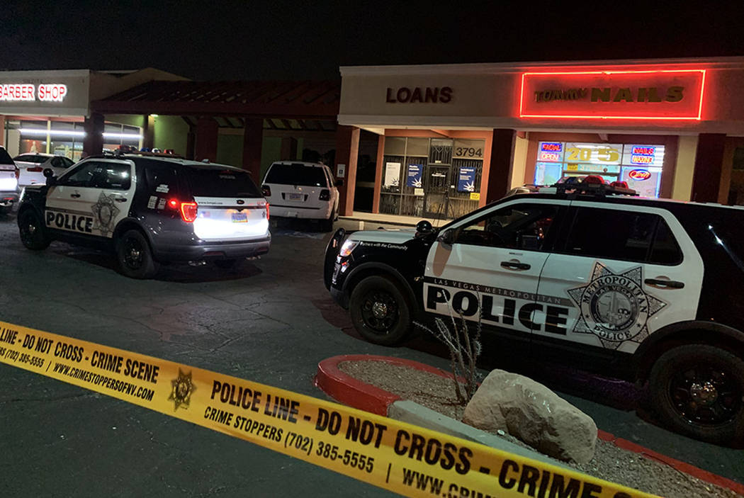 Police investigate the scene of a fatal shooting near Sandhill and Desert Inn roads in Las Vega ...