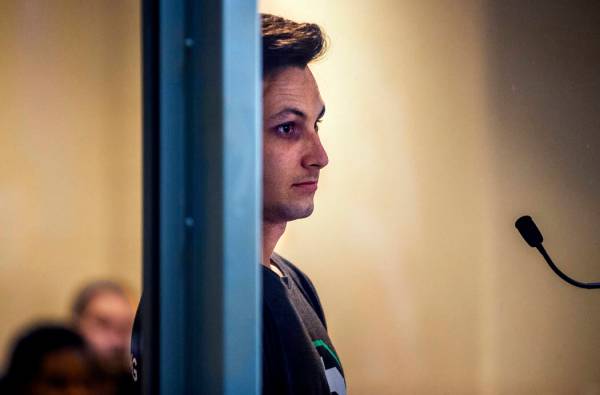 Matthew Michael Ralphs, a suspect in thefts from a wedding party, hides behind a window frame d ...