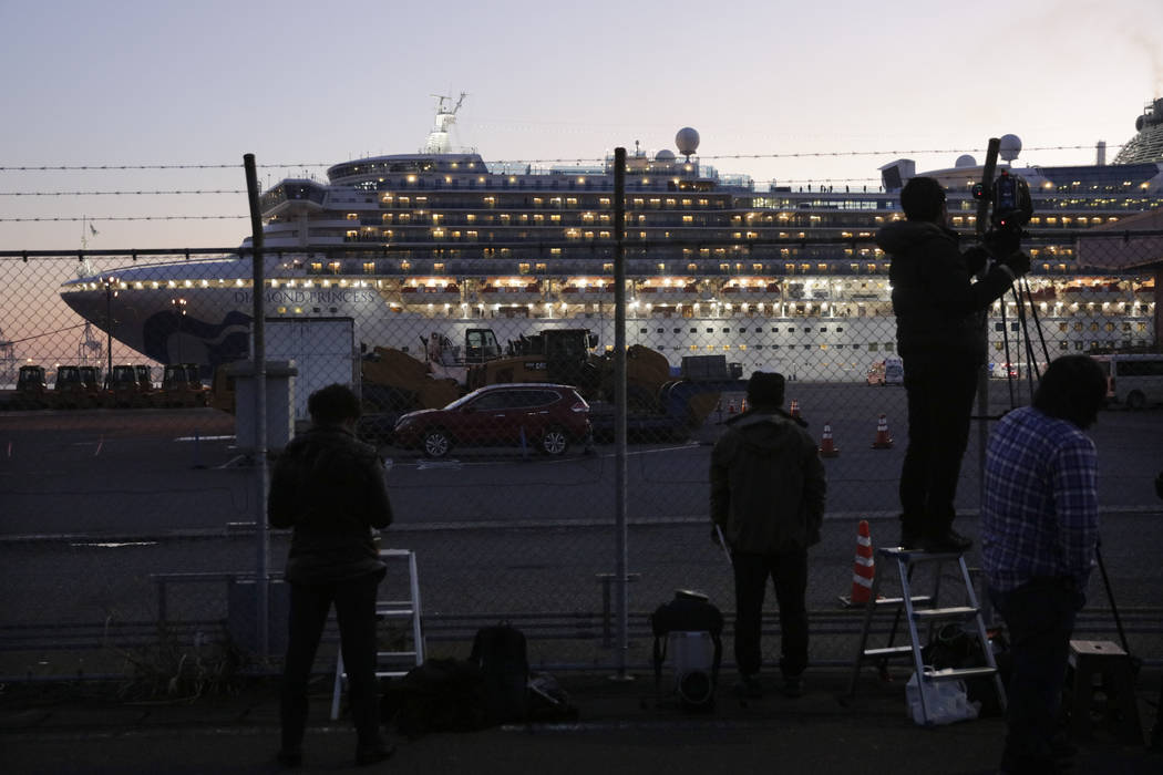 Videographers film the quarantined Diamond Princess cruise ship Thursday, Feb. 13, 2020, in Yok ...