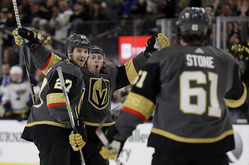 Vegas Golden Knights center Jonathan Marchessault, rear, celebrates after scoring against the S ...