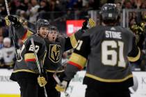 Vegas Golden Knights center Jonathan Marchessault, rear, celebrates after scoring against the S ...