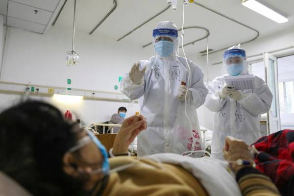 Medical workers check on the conditions of patients in Jinyintan Hospital, designated for criti ...