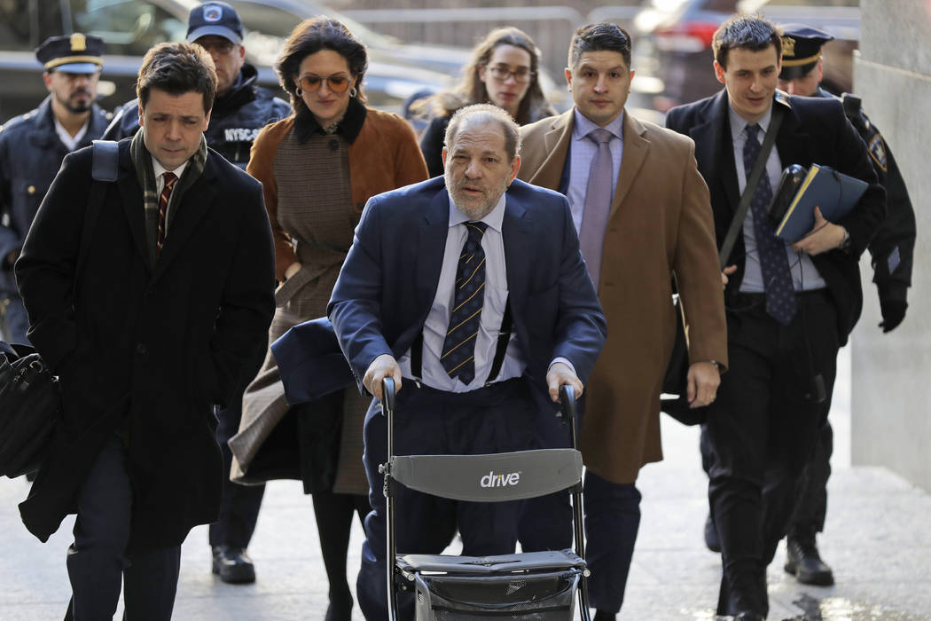 Harvey Weinstein, center, arrives at a Manhattan courthouse for his rape trial in New York, Fri ...