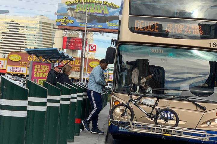 People board a bus on Las Vegas Boulevard near Sahara Avenue in Las Vegas. (Mick Akers/Las Vega ...