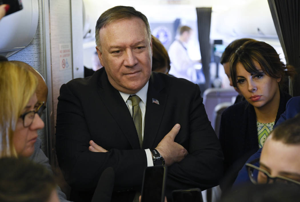 Secretary of State Mike Pompeo takes questions from reporters during a flight from Andrews Air ...