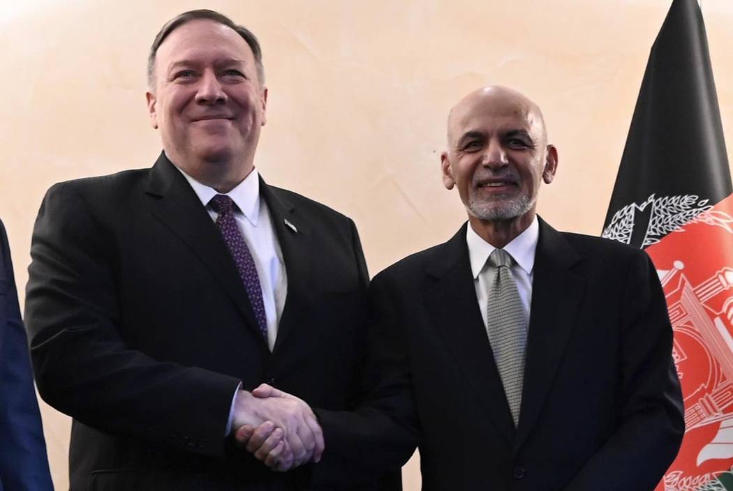 US Secretary of State Mike Pompeo, left, shakes hands with Afghan President Ashraf Ghani,during ...