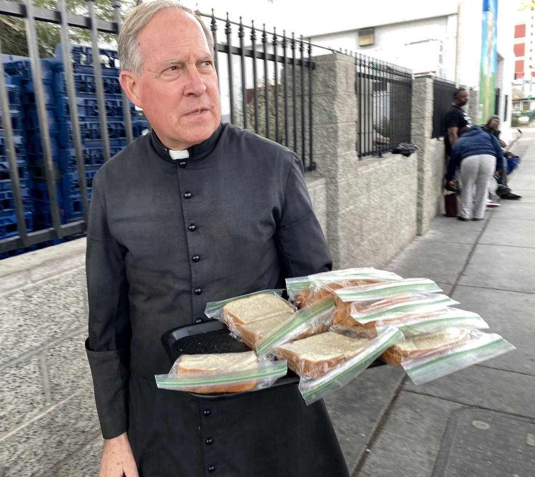 The Rev. Courtney Krier offers free sandwiches outside St. Joseph's Catholic Church on North Ni ...