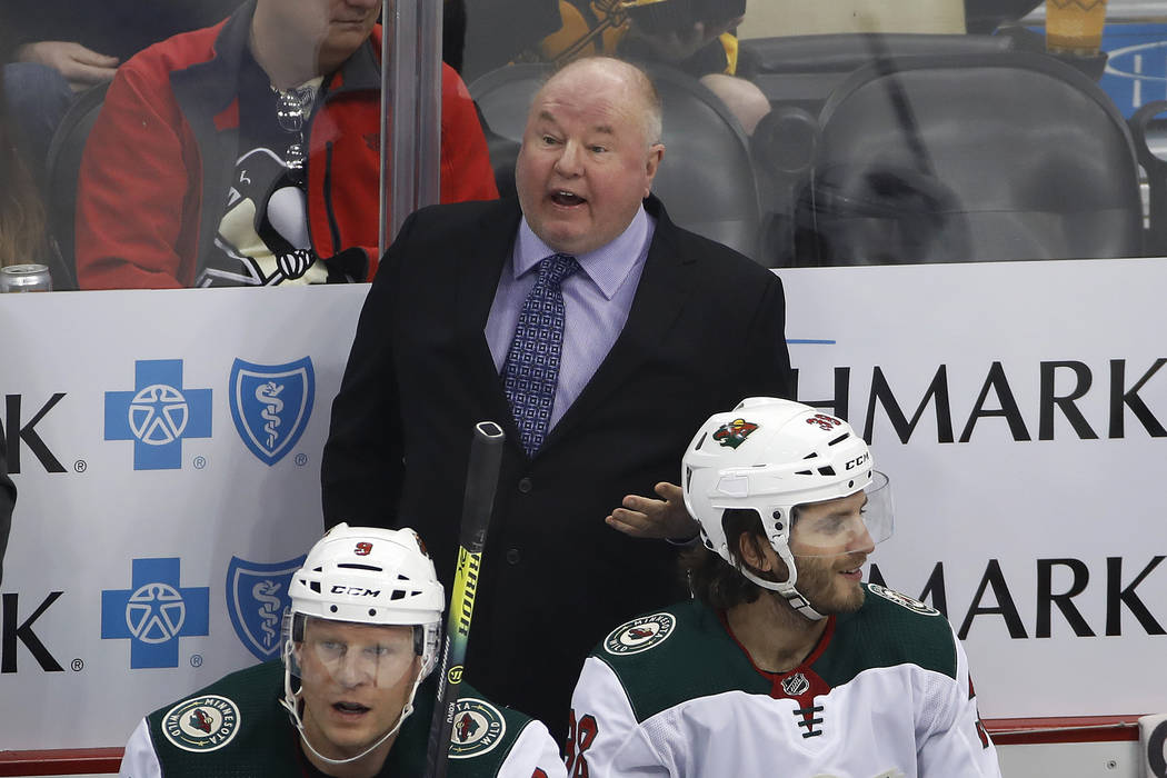 Minnesota Wild coach Bruce Boudreau stands behind the bench during the first period of the team ...
