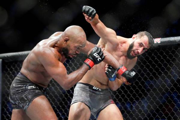 Jon Jones, left, and Dominick Reyes, right, during a light heavyweight mixed martial arts bout ...