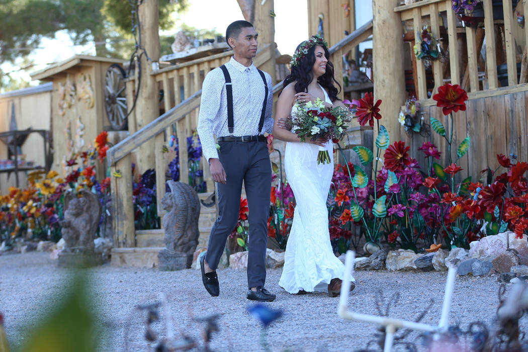 Mely Ayala, right, of San Diego gets walked to get married by her brother Luis Elias during the ...