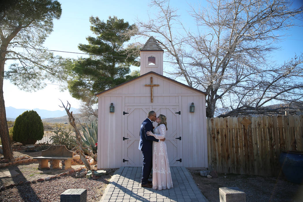 Richard Raney and Laura Eshelman of Overland Park, Kan., share a kiss in their wedding during t ...