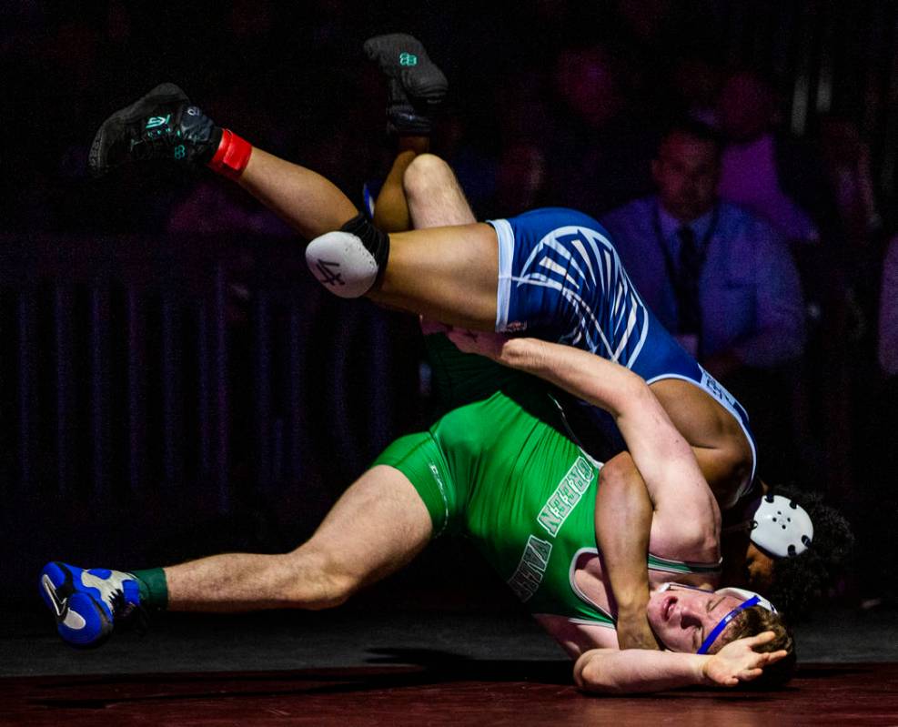Foothill's Micah Schneider, top, drives Green Valley's Derek Recktenwald into to the mat in the ...