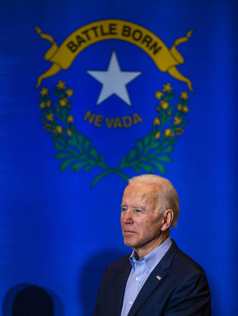 Former Vice President Joe Biden listens as U.S. Rep. Dina Titus, D-Nev., speaks during an early ...