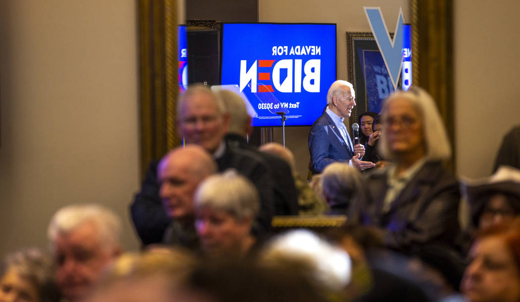 Former Vice President Joe Biden is reflected in a mirror as he speaks during an early vote even ...