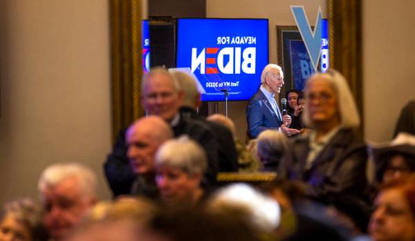 Former Vice President Joe Biden is reflected in a mirror as he speaks during an early vote even ...