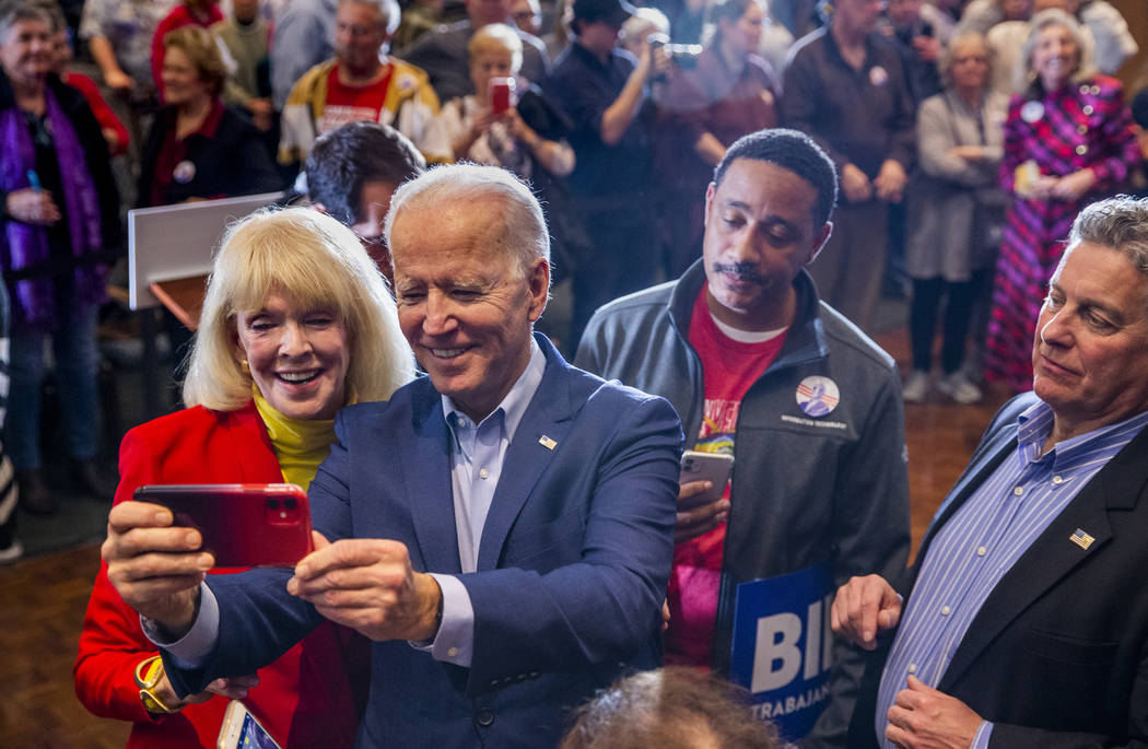 Former Vice President Joe Biden does a selfie with an invited guest following an early vote eve ...