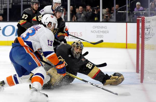 New York Islanders forward Mathew Barzal (13) shoots as Vegas Golden Knights goalie Marc-Andre ...