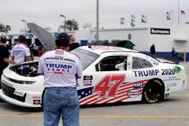 Crew members make adjustments to Joe Nemecheck's car sponsored by Patriots PAC of America durin ...