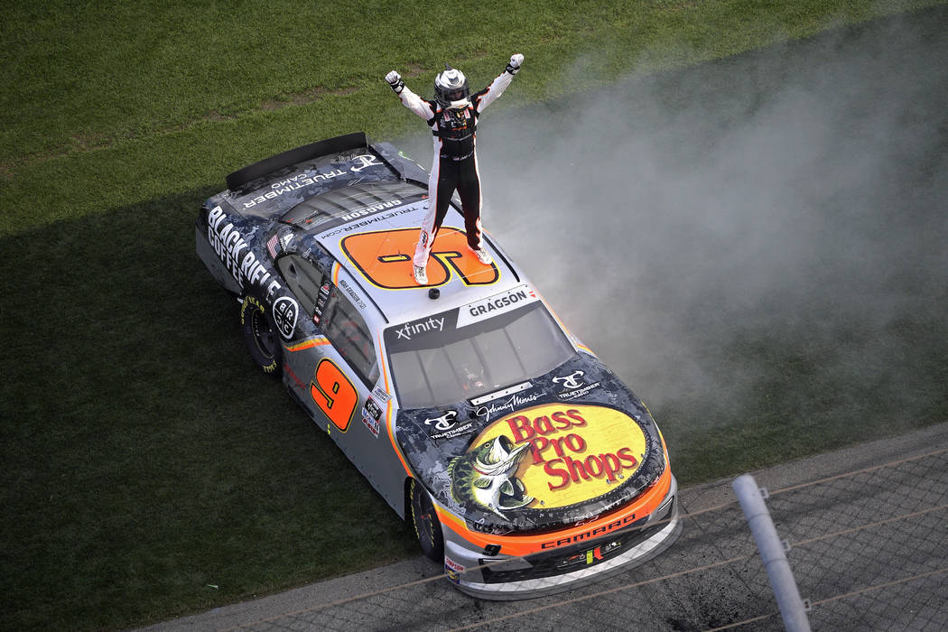 Noah Gragson (9) celebrates on the roof of his car at the finish line after winning a NASCAR Xf ...