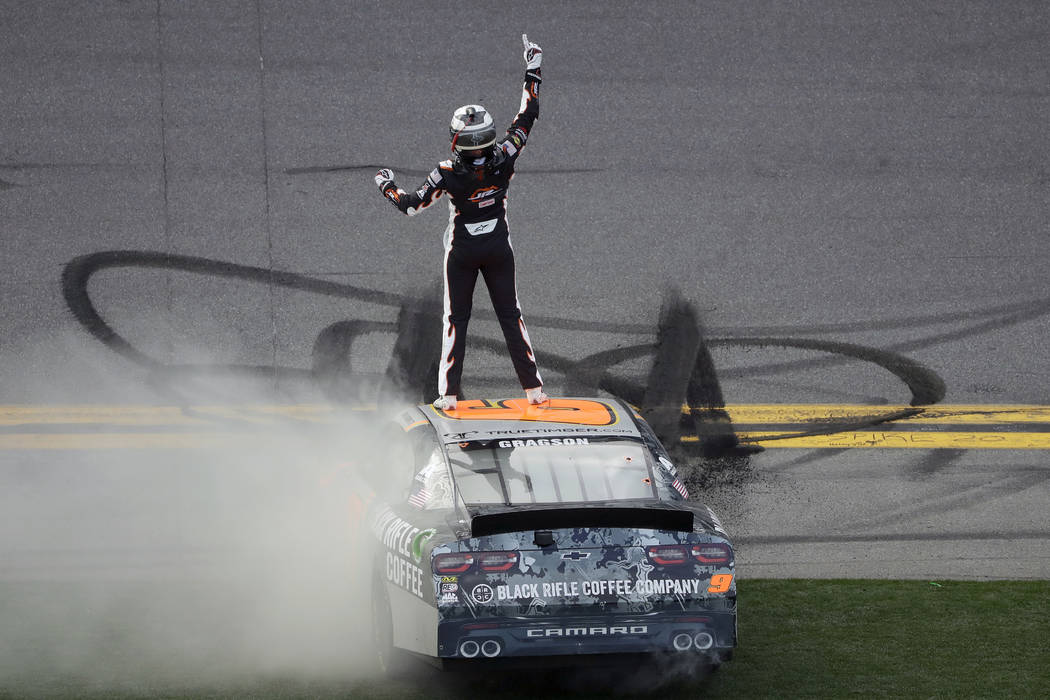 Noah Gragson celebrates on the roof of his car after winning the NASCAR Xfinity series auto rac ...