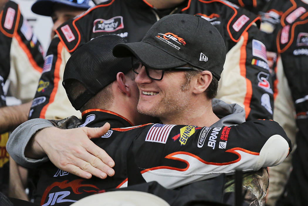 Car owner Dale Earnhardt Jr., right, hugs driver Noah Gragson in Victory Lane after he won the ...