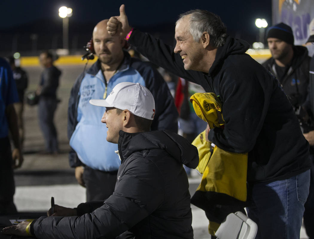 Lee McCreary, right, takes a photo with NASCAR star Kyle Busch before the start of the Star Nur ...