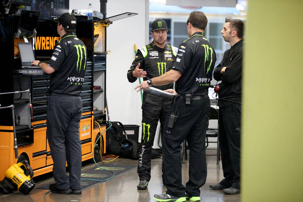 NASCAR Cup Series driver Kurt Busch (1) third from right, talks to his crew after practice for ...