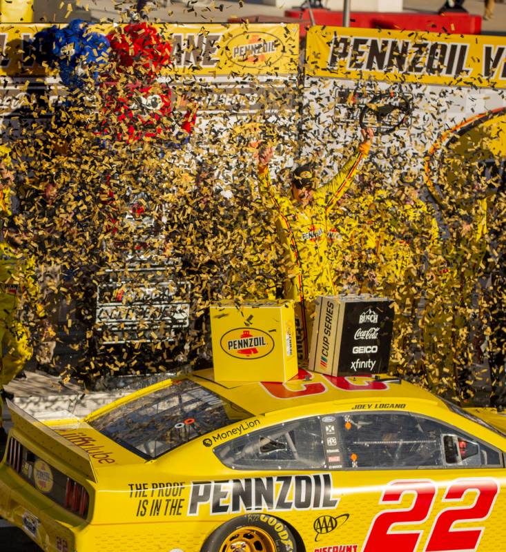 Joey Logano (22) is blasted with confetti as he celebrates in the winner's circle following the ...