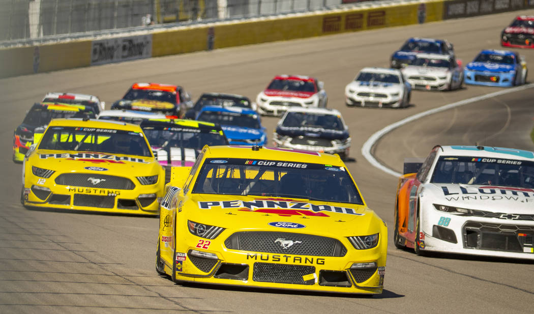 Joey Logano (22, center) is in the thick of things on the first turn during the Pennzoil 400 pr ...