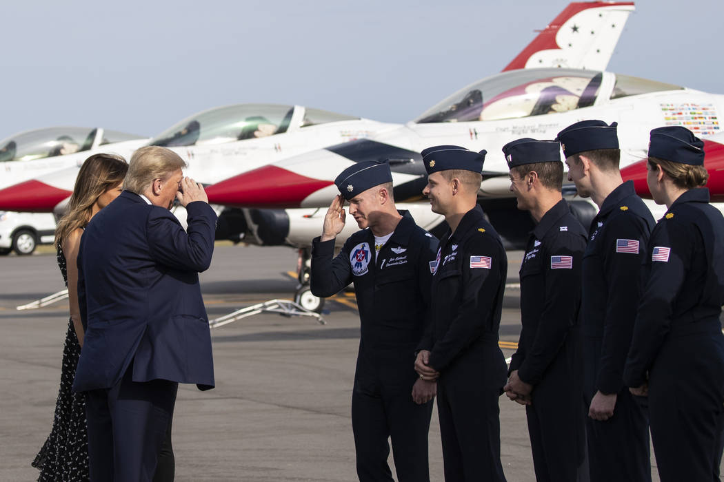 President Donald Trump and first lady Melania Trump greet racing legend Richard Petty, second f ...