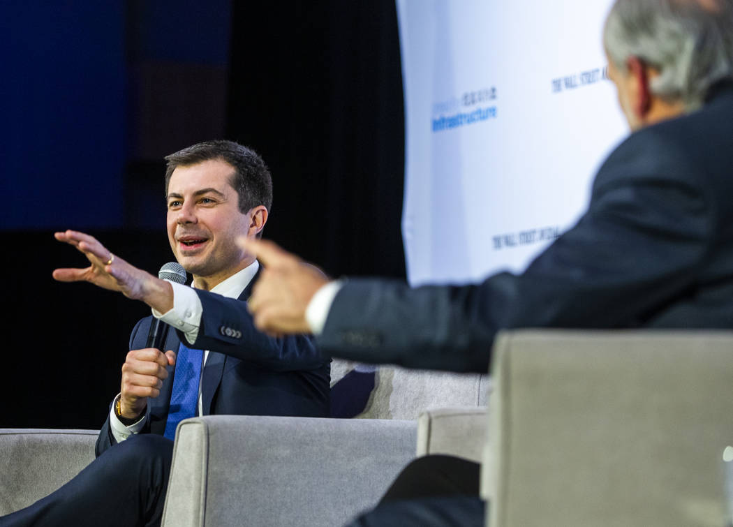 Former South Bend, Ind., Mayor Pete Buttigieg, left, answers questions from The Wall Street Jou ...