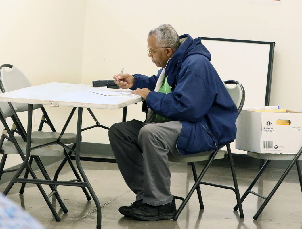 Reginald Bates selects candidates during the last day of early voting in the Nevada Democratic ...