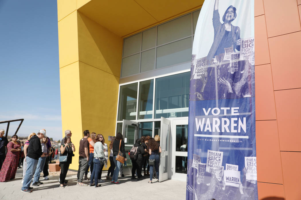 Individuals arrive to hear Sen. Elizabeth Warren speak ahead of a town hall at College of South ...