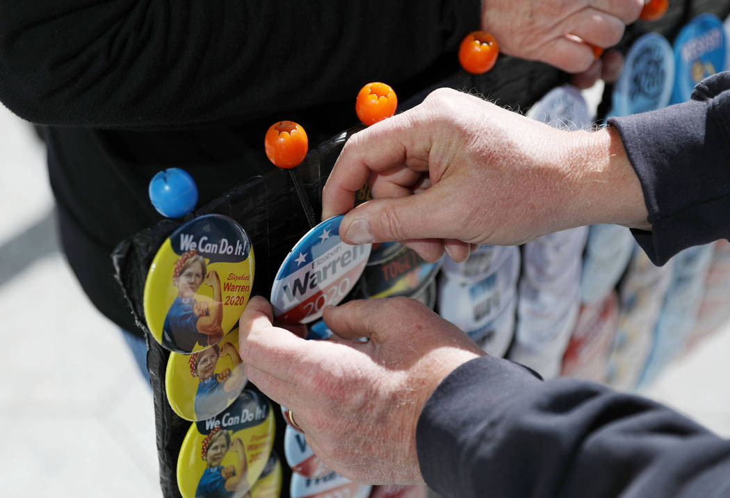 A Sen. Elizabeth Warren supporter purchases a pin before Warren speaks ahead of a town hall at ...