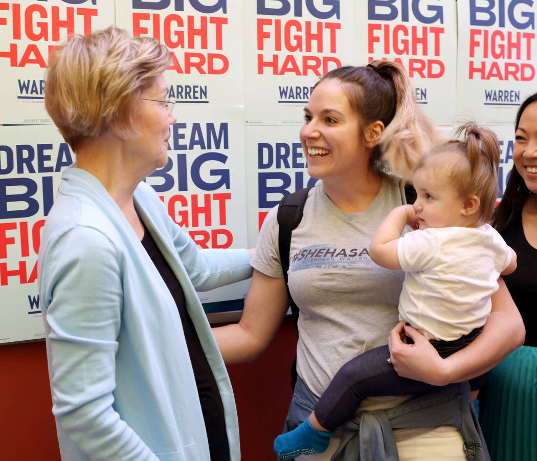 Sen. Elizabeth Warren meets supporter Brett Hagerty and her daughter Margot, 1, at College of S ...