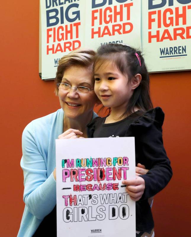 Sen. Elizabeth Warren takes a photograph with Davina Lidikay, 5, at College of Southern Nevada ...