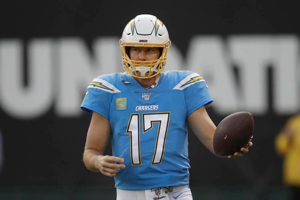Los Angeles Chargers quarterback Philip Rivers (17) warms up before an NFL football game agains ...