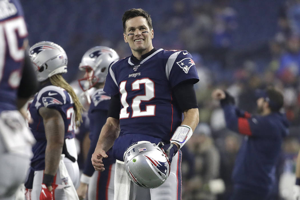 New England Patriots quarterback Tom Brady warms up before an NFL wild-card playoff football ga ...